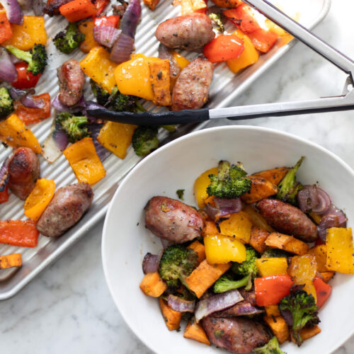 roasted bratwurst and veggies on a pan