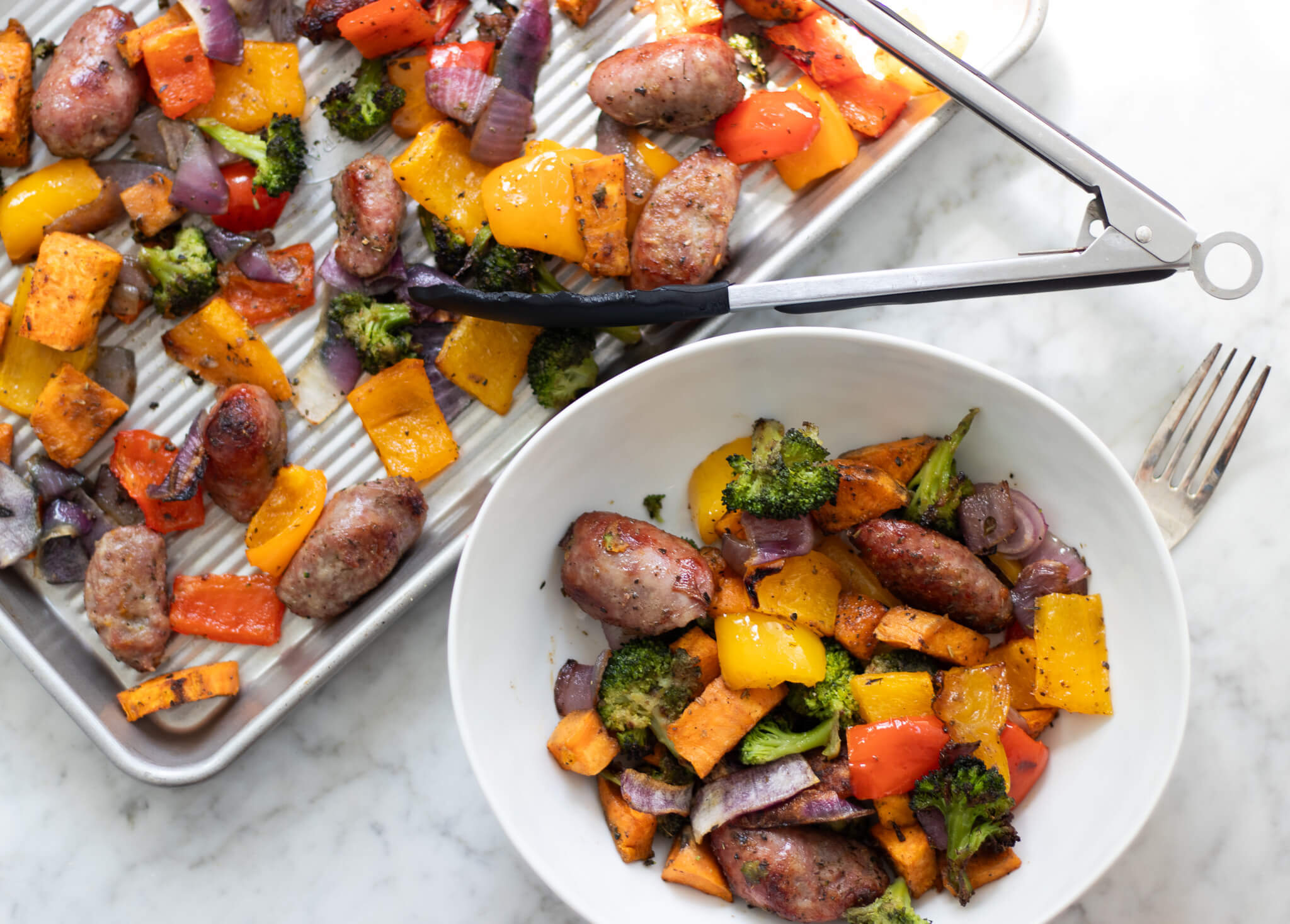 roasted bratwurst and veggies on a pan