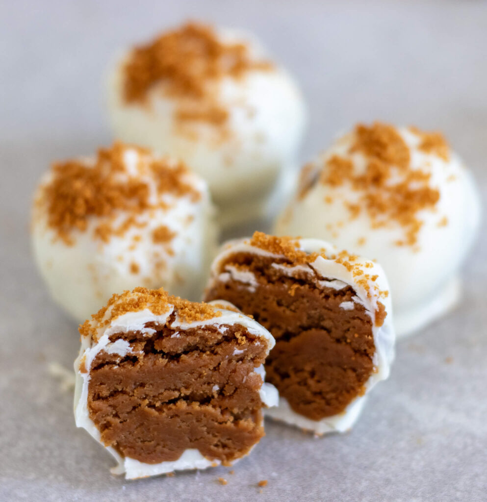 four cookie butter truffles with one taken a bite out of