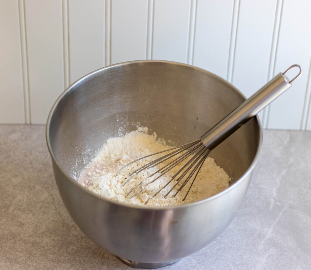 flour and salt and baking powder in a bowl with whisk