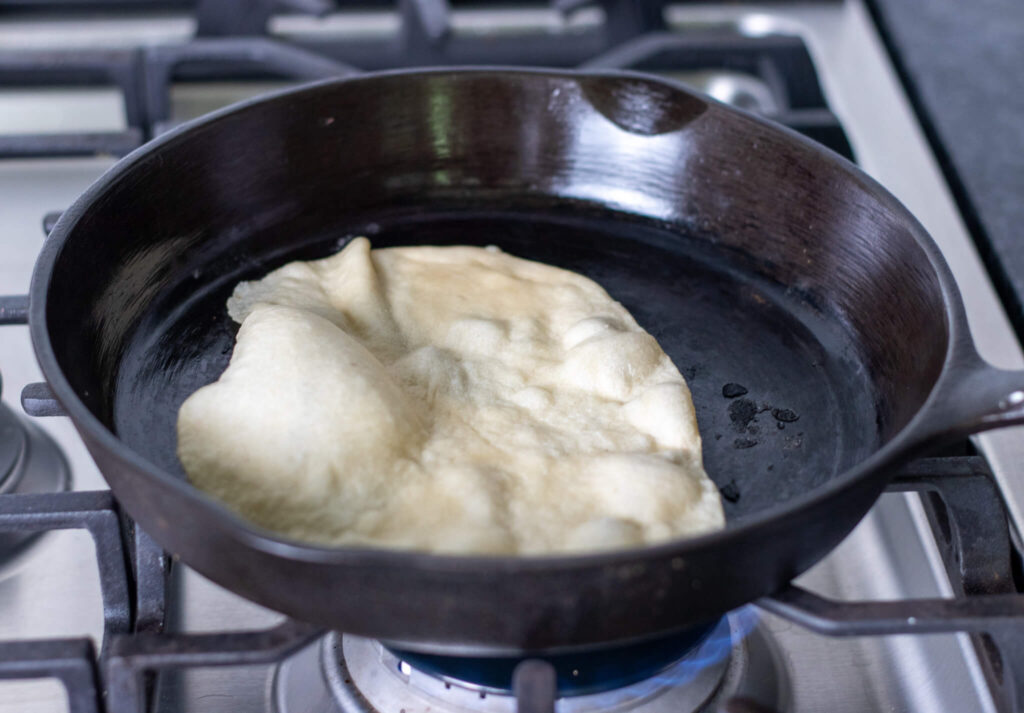 tortilla cooking in a hot pan