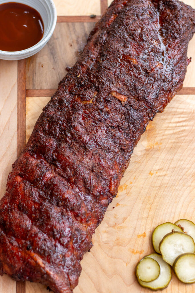 rack of ribs with barbeque sauce and pickles