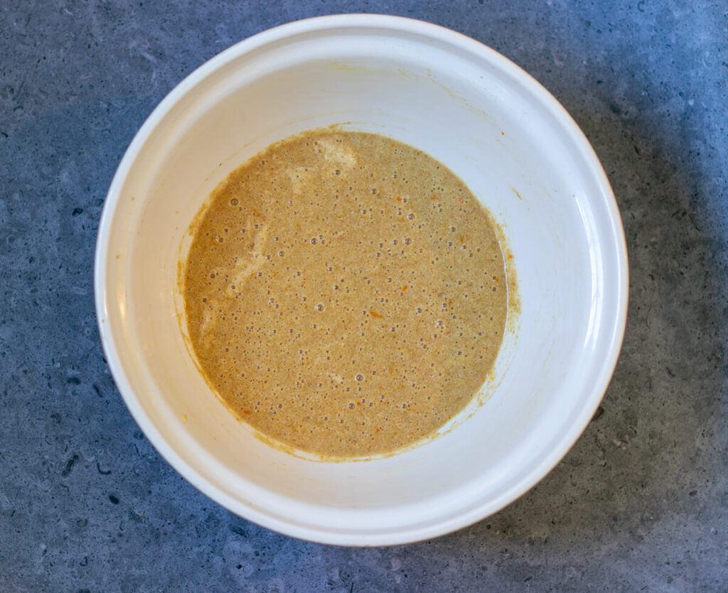 bowl of dry ingredients added to wet ingredients for muffins