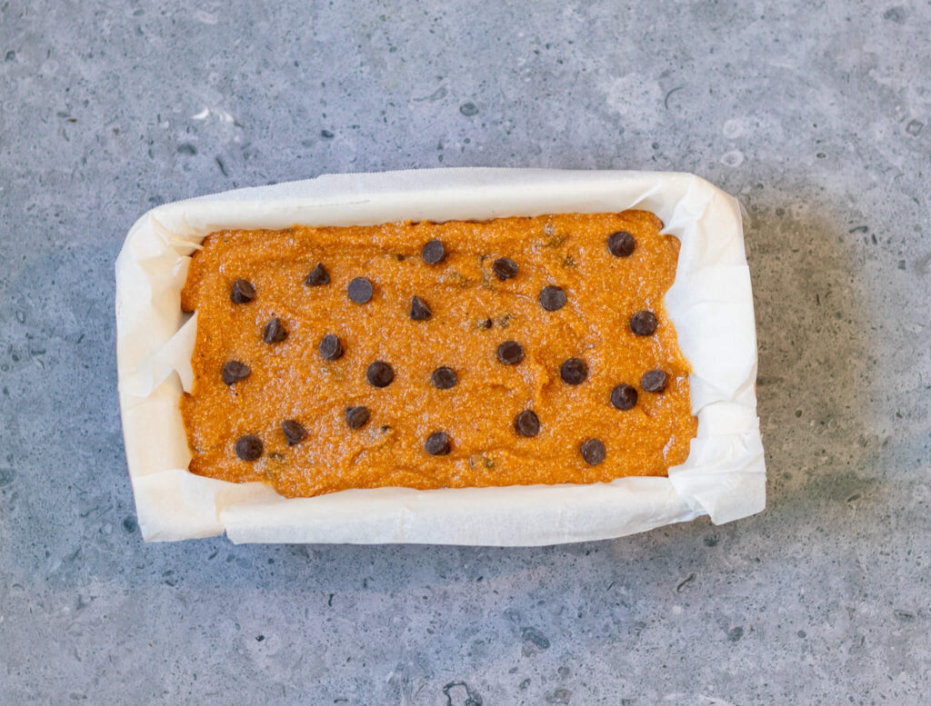 pumpkin bread in a loaf pan with chocolate chips