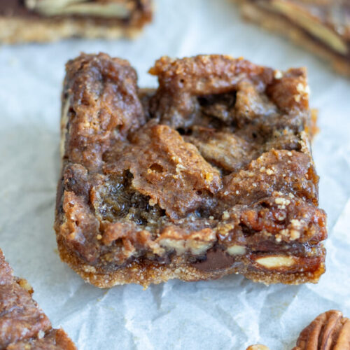 chocolate pecan pie bar with freshly milled flour in the center of a pan