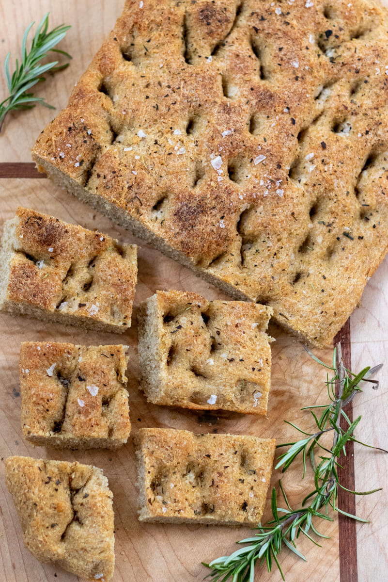 whole wheat sourdough focaccia on a cutting board with rosemary